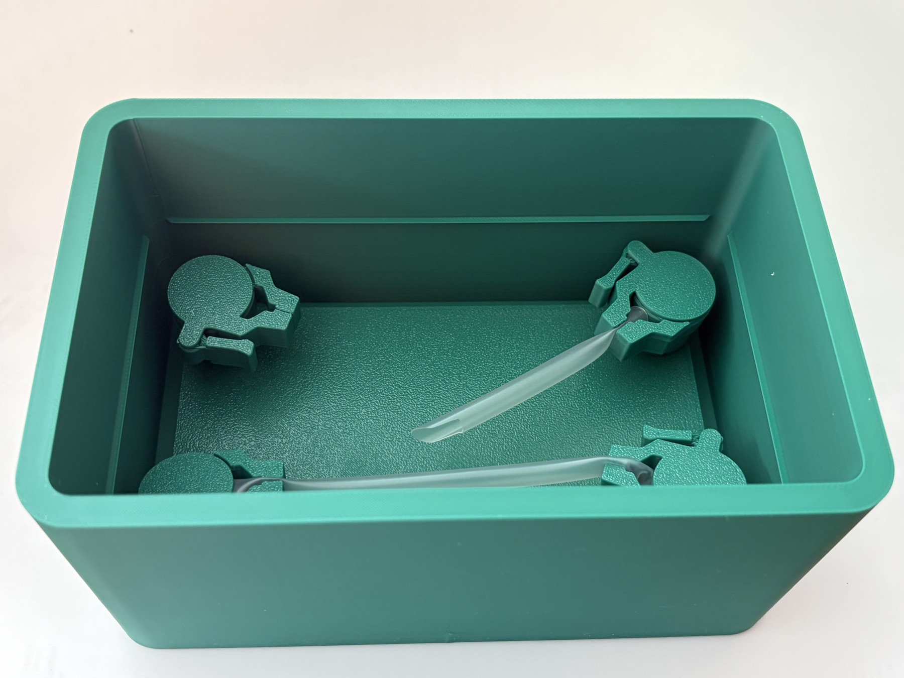 View down into the simulator case, showing four adjustable vessel clamps and simulated vessels.